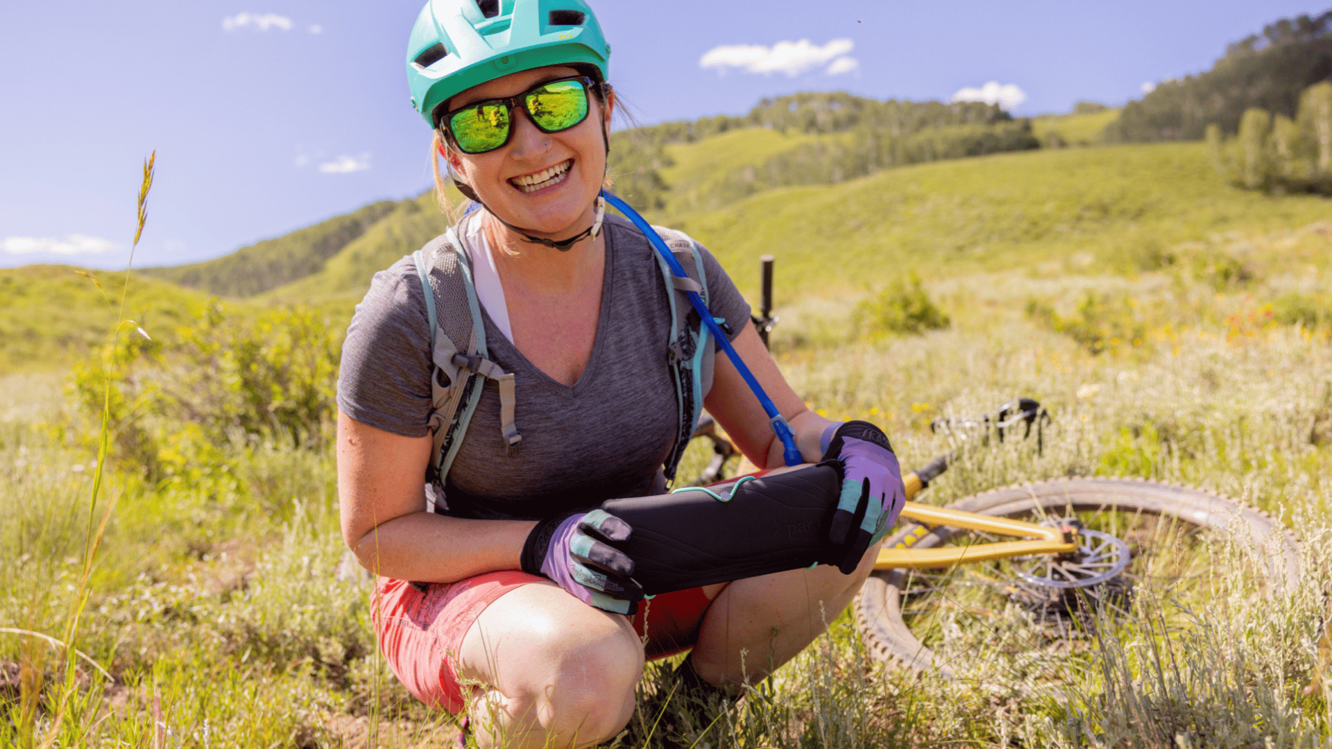 A woman holding the PACT Outdoor Bathroom Kit which makes it easy for women to pee and poop in the backcountry.