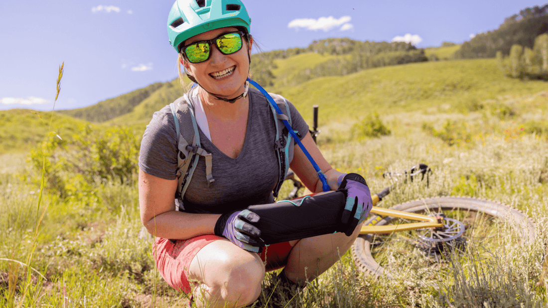 A woman holding the PACT Outdoor Bathroom Kit which makes it easy for women to pee and poop in the backcountry.