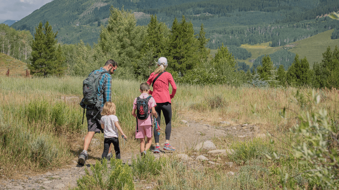 2 parents and 2 toddlers preparing to camp.