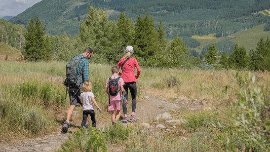 2 parents and 2 toddlers preparing to camp.